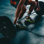 person-holding-barbell-841130