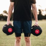person-holding-black-dumbbells-1032117